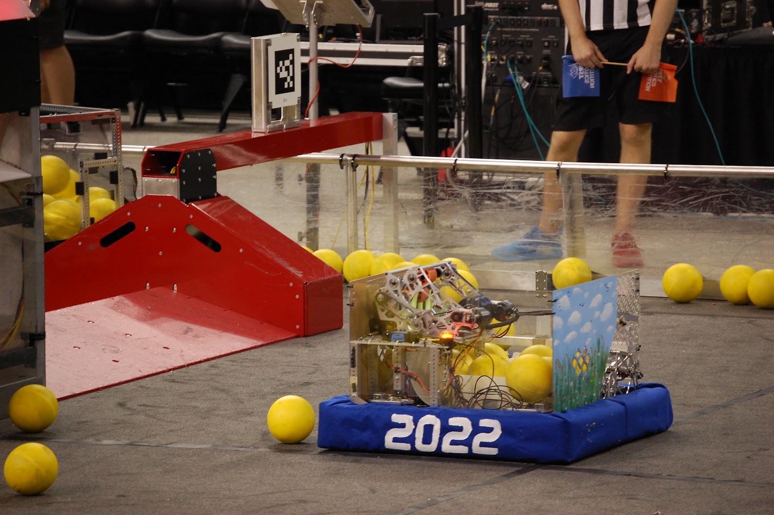 Blue alliance robot on the field with game pieces in its hopper, 2025–26 season.