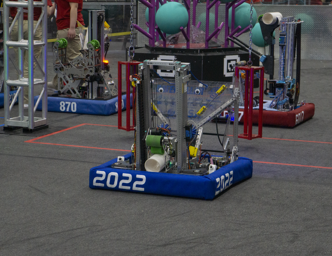 Blue alliance robot on the field with a game piece visible in its outtake, 2024–25 season.